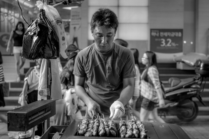 Man selling meat sticks
