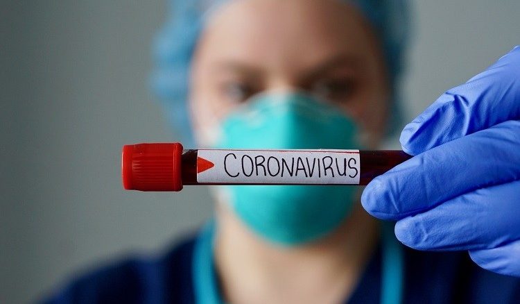 Nurse wearing respirator mask holding a positive blood test result for the new rapidly spreading Coronavirus, originating in Wuhan, China